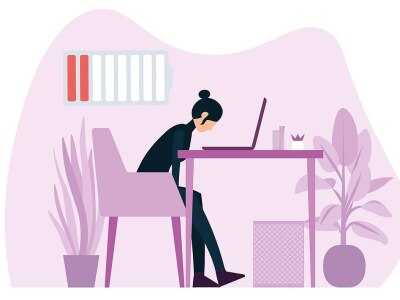 Clipart silhouette of woman hunched over a desk and laptop with a low battery symbol in the upper left.