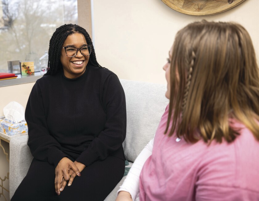 Aliah Hall talks with a student