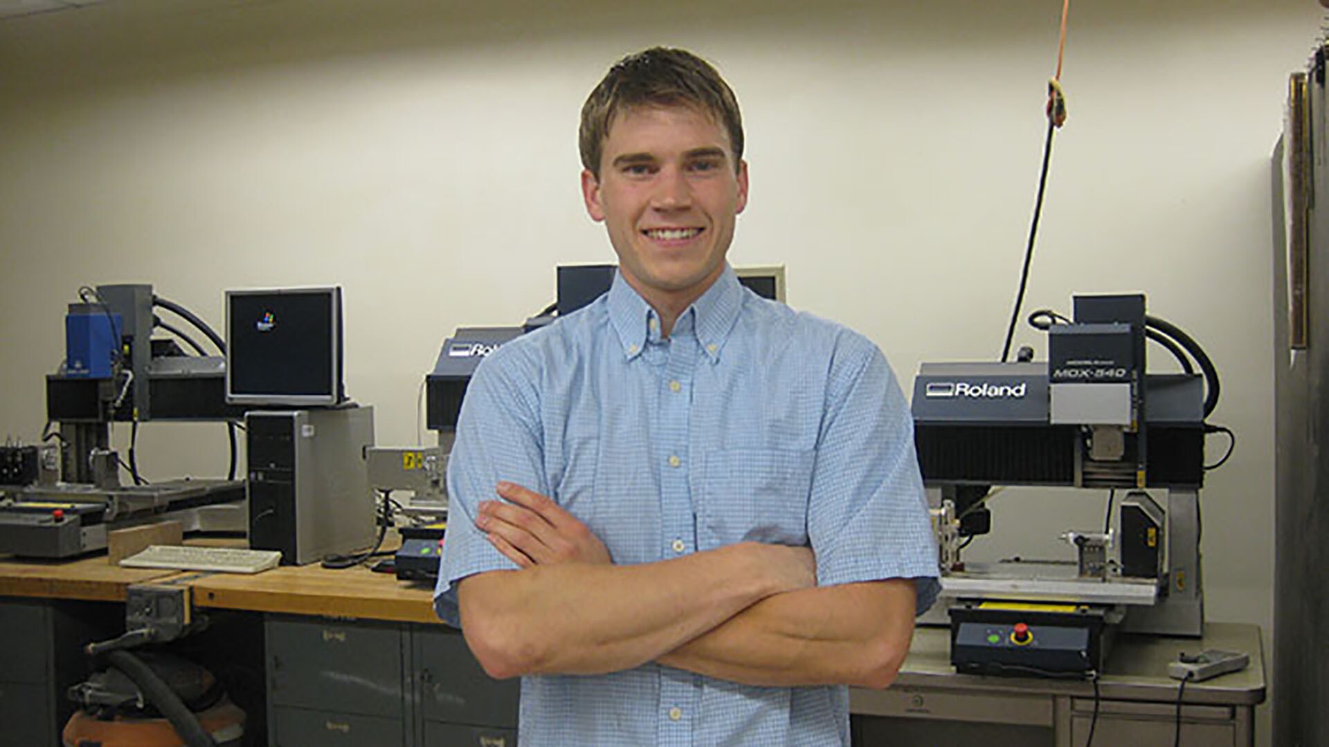 Student standing in front of small table top milling machines