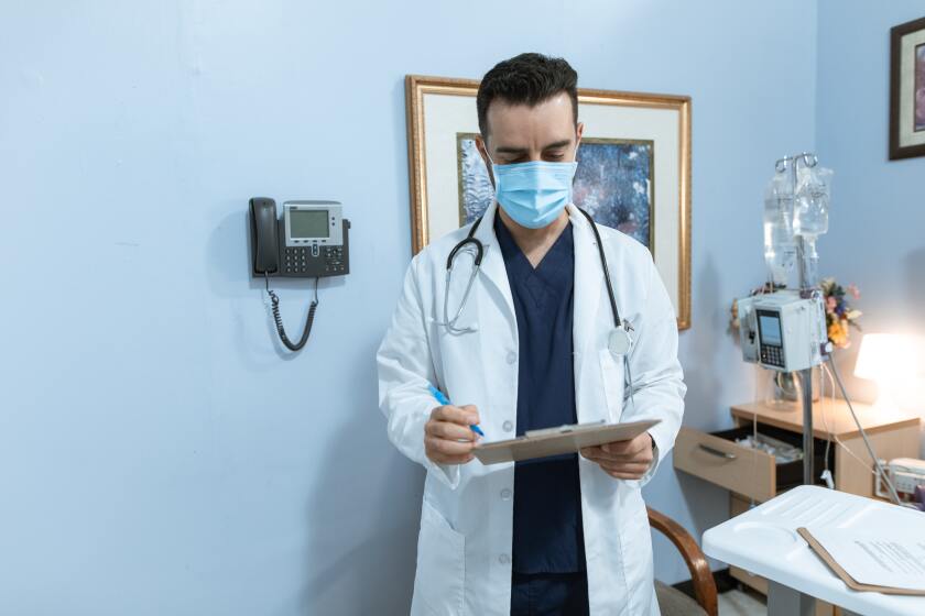 Doctor looking at clipboard