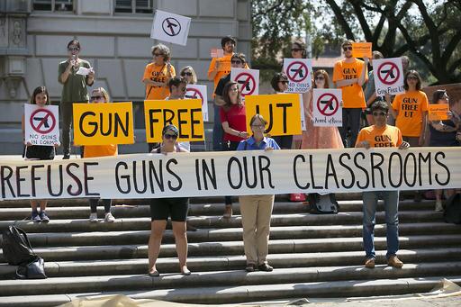FILE - In this Oct. 1, 2015 file photo in Austin, Texas, protestors gather on the West Mall of the University of Texas campus to oppose a new state law that expands the rights of concealed handgun license holders to carry their weapons on public college campuses and as of Aug. 1, 2016, they can carry in campus buildings. Texas