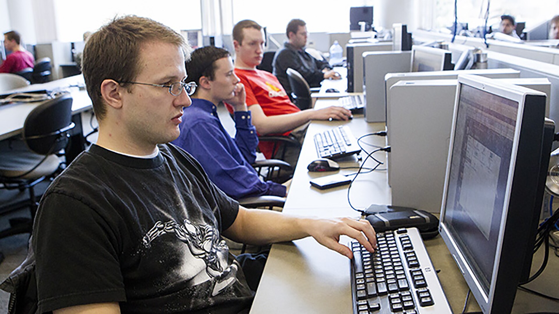 Several IT students working in a computer lab