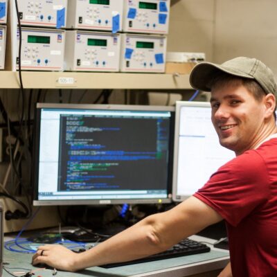 An image of a man working on a computer