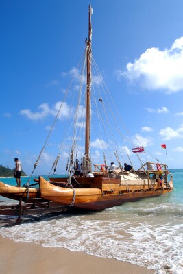 Iosepa canoe being launched onto the beach