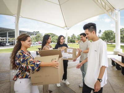 people giving boxes to others