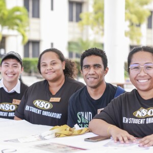 Hale Pavilion with four people smiling at the camera