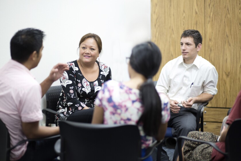 Photo of several people in a group therapy circle