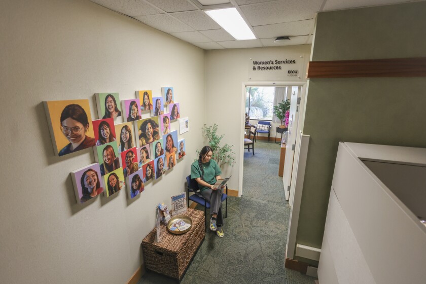 Photo of Women's Services & Resources entrance with student sitting at waiting area in front of the office.