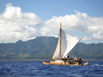 Iosepa Hawaiian canoe on the open sea with the Koolaus behind it