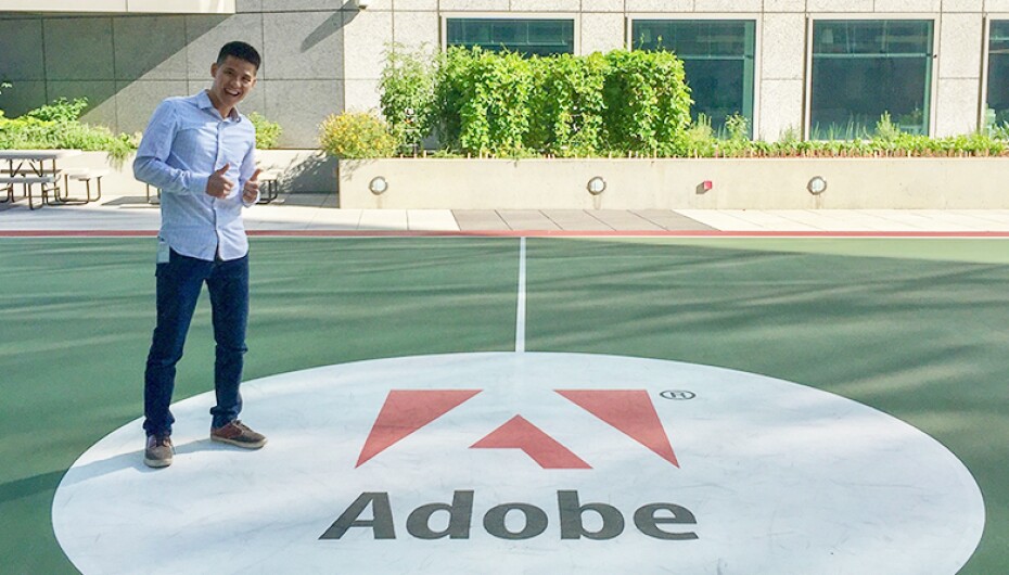 An image of Jeremy Ni standing in front of an Adobe sign