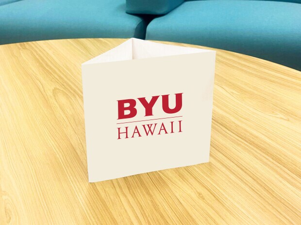 A table tent on a table in front of lounging chairs.