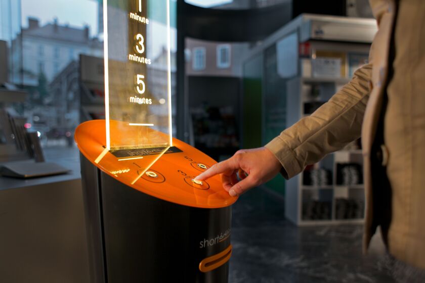 Person using the Short Édition short story dispensers.
