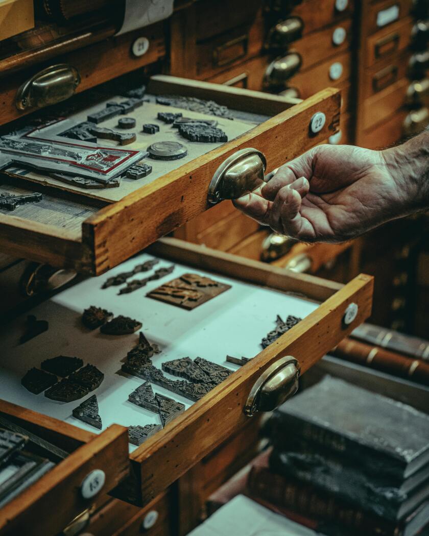 Drawer of stamps used in printing presses.