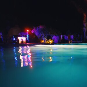 A pool and night with lights.