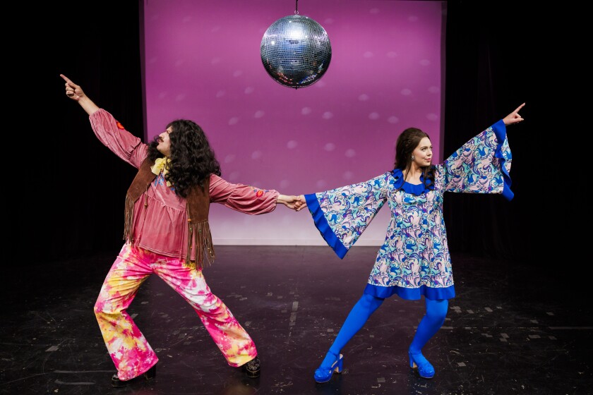 Two students in the Opera pose in 1970s dance clothes.