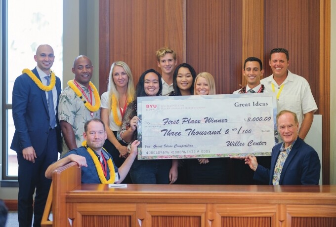 The Great Ideas first place winners stand with a check for three thousand dollars with the Great Ideas judges and BYUH staff members