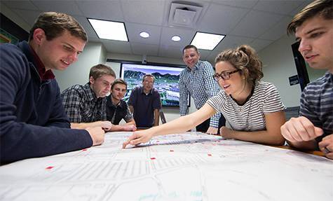 The virtual tour team looks over the map used to plan out the project.