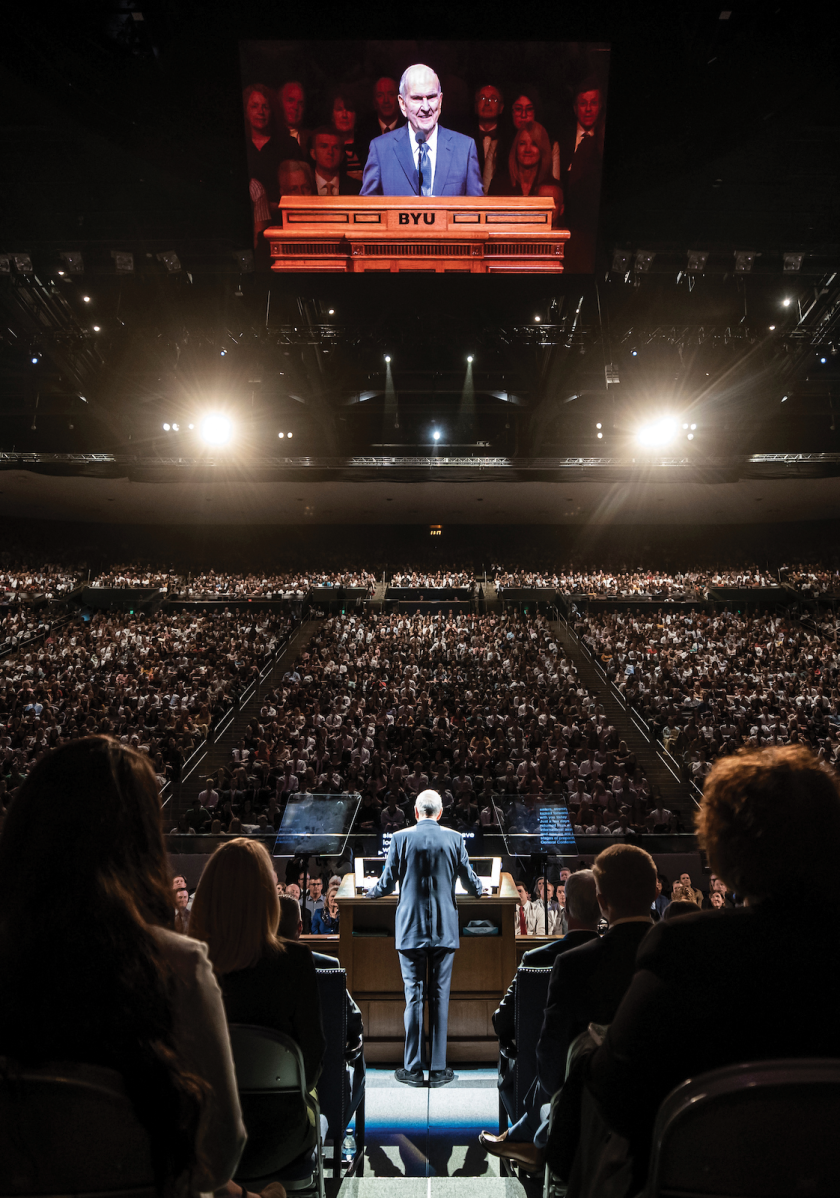 An image of President Russell M. Nelson giving a devotional in the BYU Marriott Center