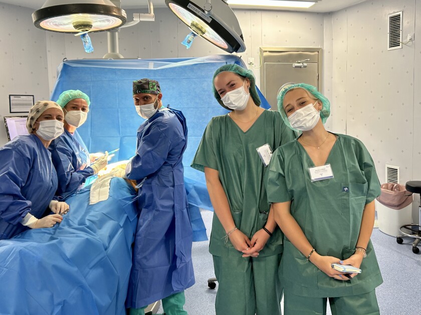 People stand in a room during a medical procedure