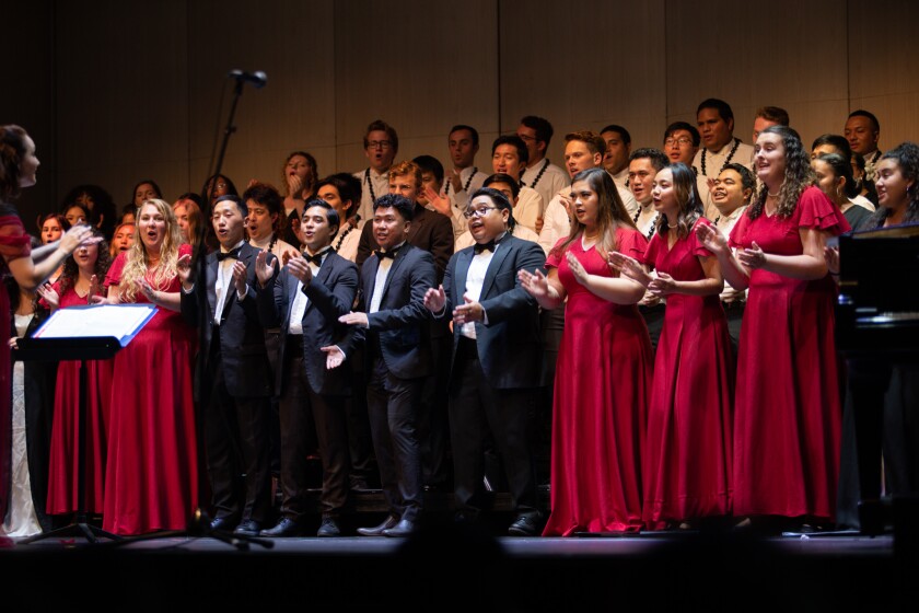 A group of students singing in the choir concert.