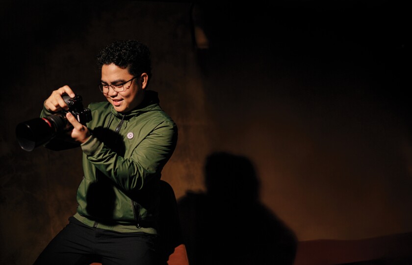 Jenard Cian Perez holds his camera.