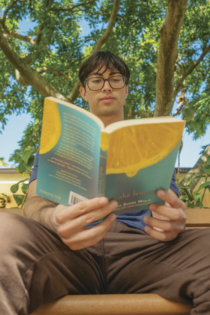 Nich Arancibia reads a book in one of the
McKay building courtyards.