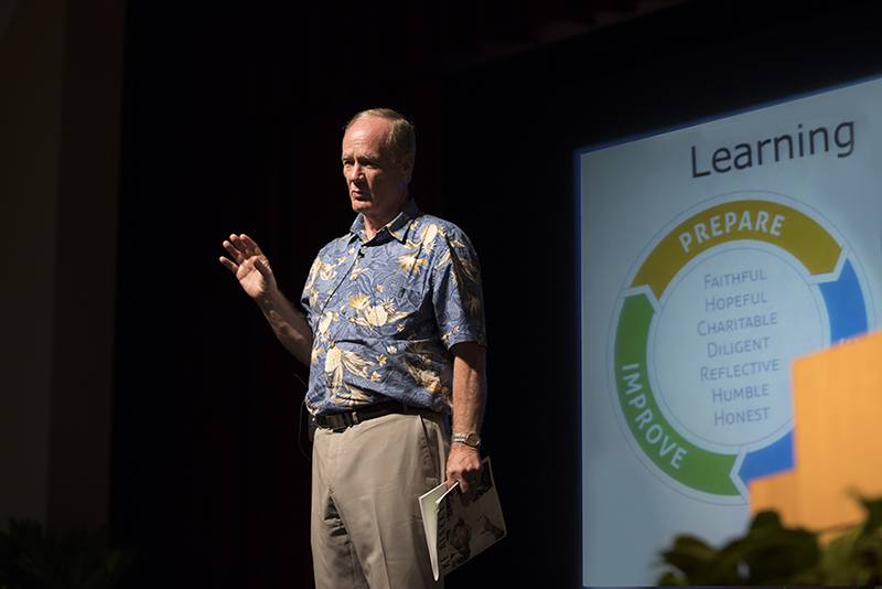 President Tanner stands center-stage and presents the revised Framework for Learning and Teaching on September 1, 2017. The circle flow-chart of the revised Framework in the background.