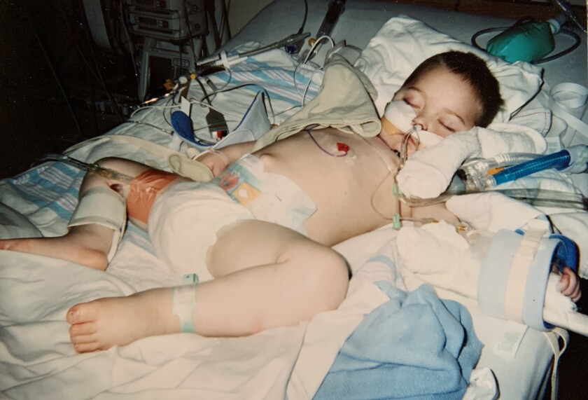 Preston Bliss lays in a hospital bed as a toddler.
