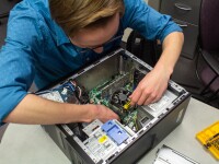 Physical Facilities Information Support repairing a computer.