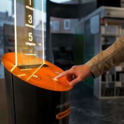 Person using the Short Édition short story dispensers.