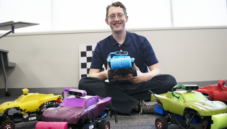 student with robotic cars