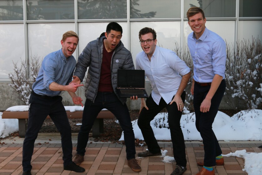 Cory Henderson, Lee Chang, Ben Johnson, and Mitch Owens are excited about the prizes they received for winning the case competition. (Michaela Proctor)