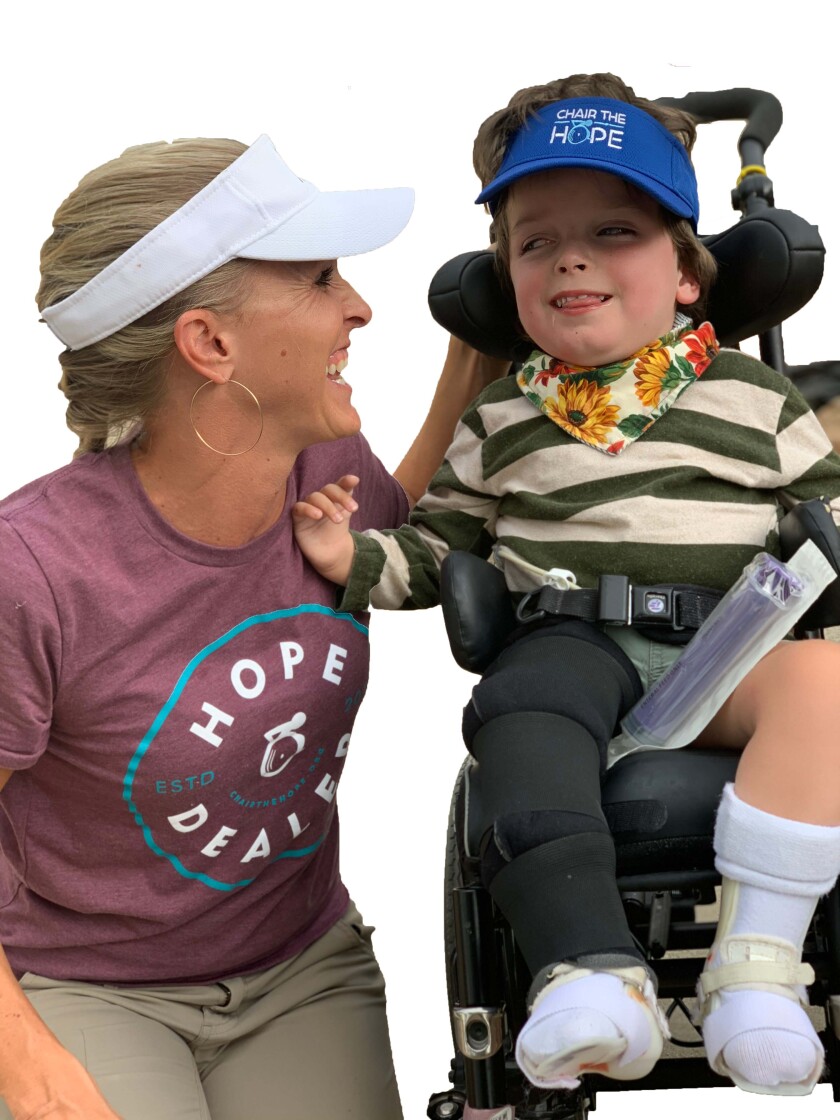 Woman and child in wheelchair smiling