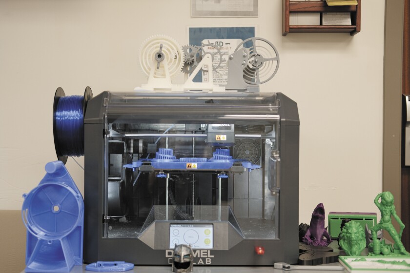 A 3D printer along with some samples printed from it