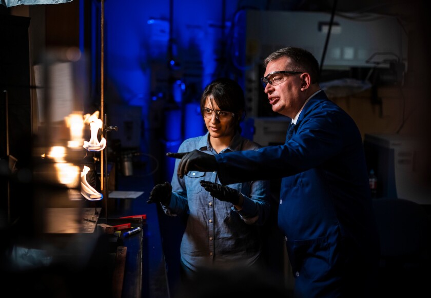 Professor Tom Fletcher in a student work in the lab.