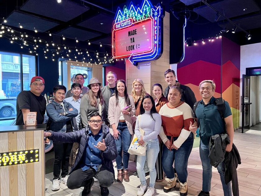 Students in their sweaters at a hotel lobby.