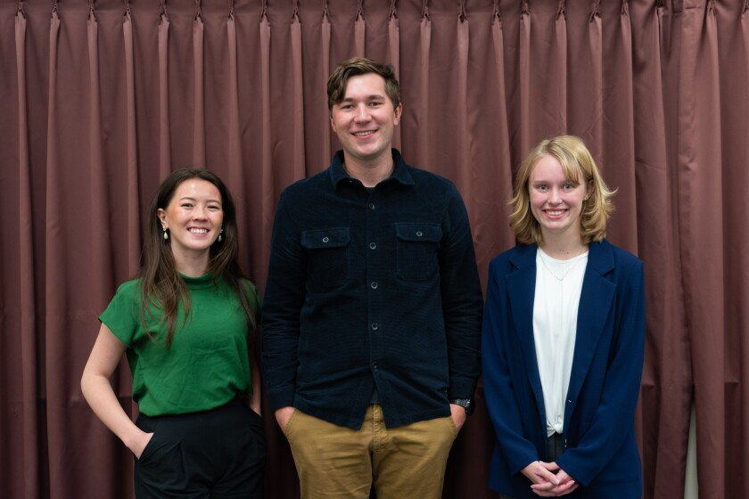 Aubrey Moedl (left) wearing a dark green short sleeved blouse stands next to Nathan Steed (right) wearing a navy blue corduroy button down with long khaki pants.