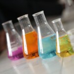 A row of chemicals in beakers.