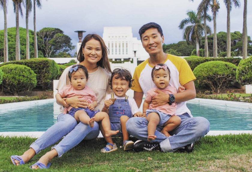 The Enkhbold Family sits in front of the Laie Hawaii Temple. They have 3 kids.