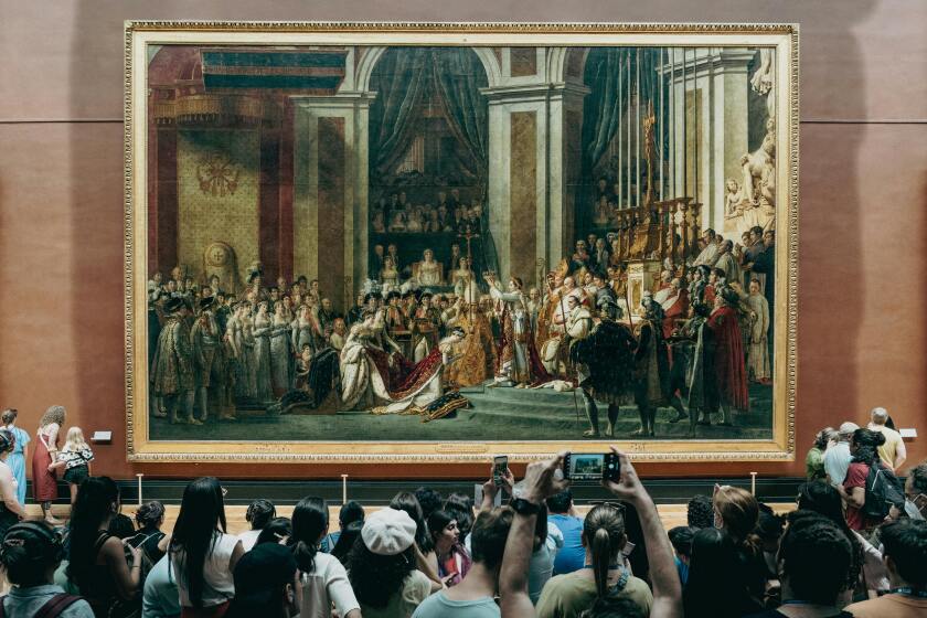 Individuals taking picture of the painting The Coronation of Napoleon by Jacques-Louis David.